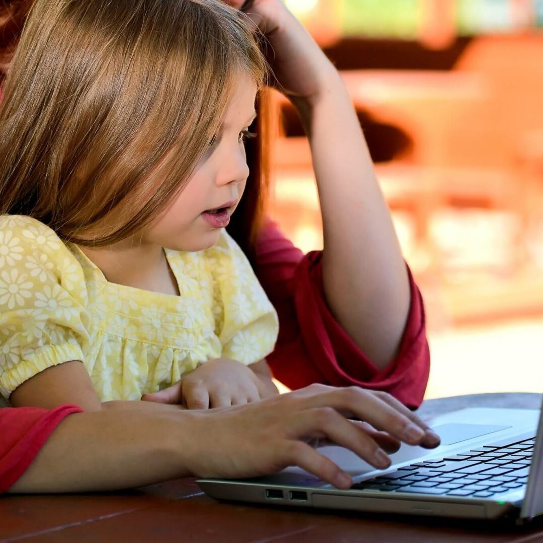 Teacher reading to toddlers at modern daycare learning centers facility